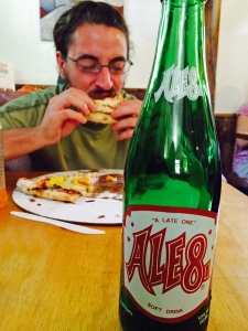 Dingo chomping down on some great pizza and drinking an Ale 8! Photo: Melissa